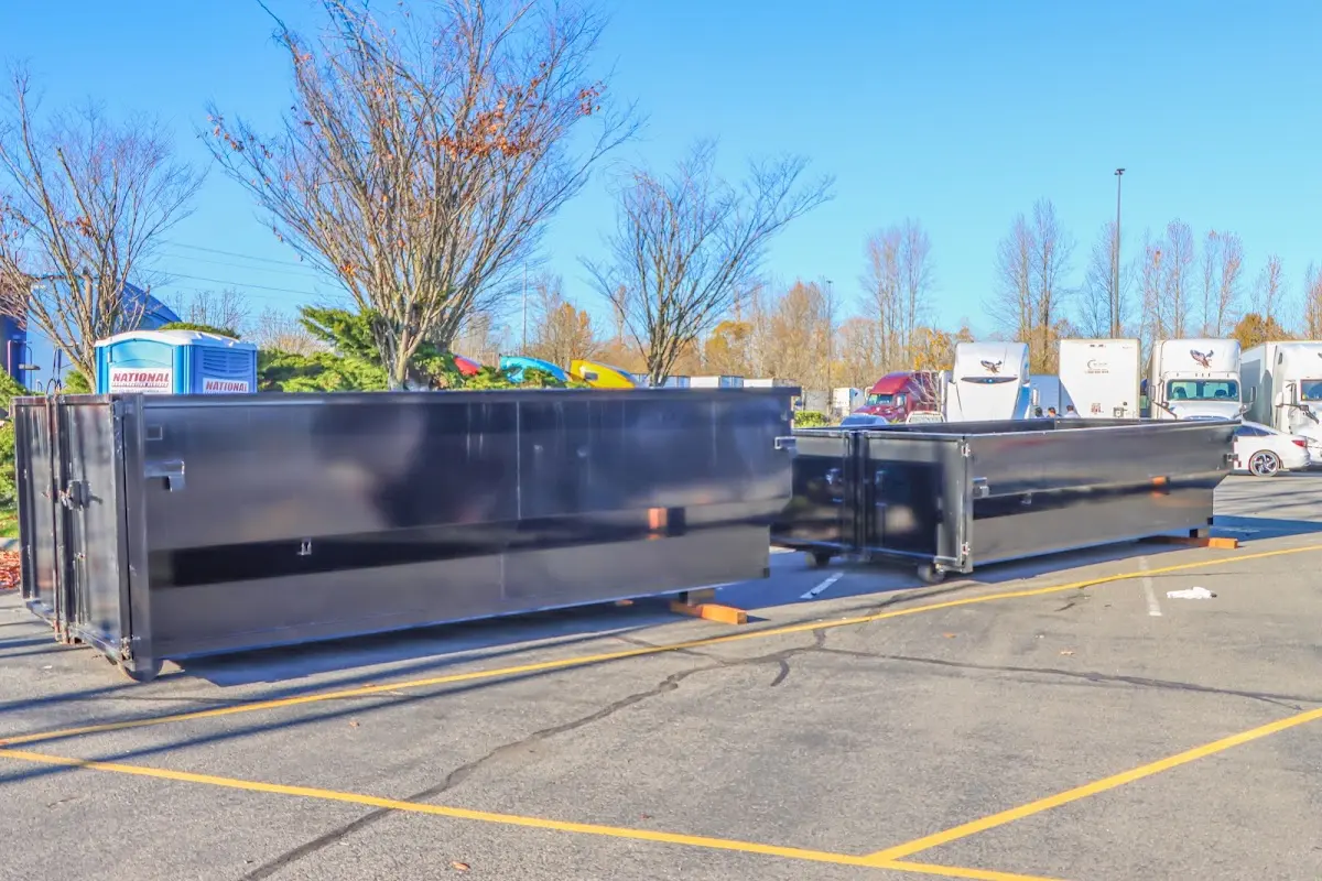 Professional dumpster rental service with roll-off container on residential driveway in Sevierville
